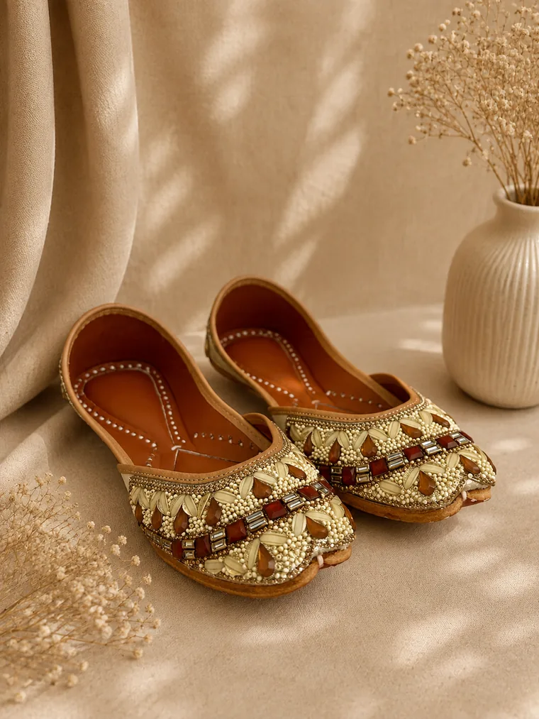 Close view of dense gold and jewel-toned beadwork across the upper of a Royal Ember jutti.