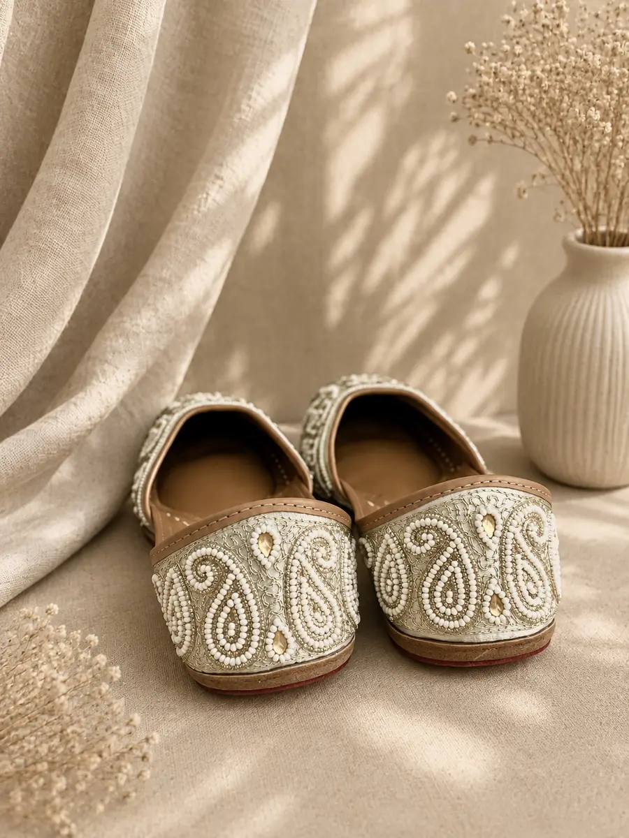 Ivory Grace juttis seen from behind, the pearl paisley motif visible across each toe.