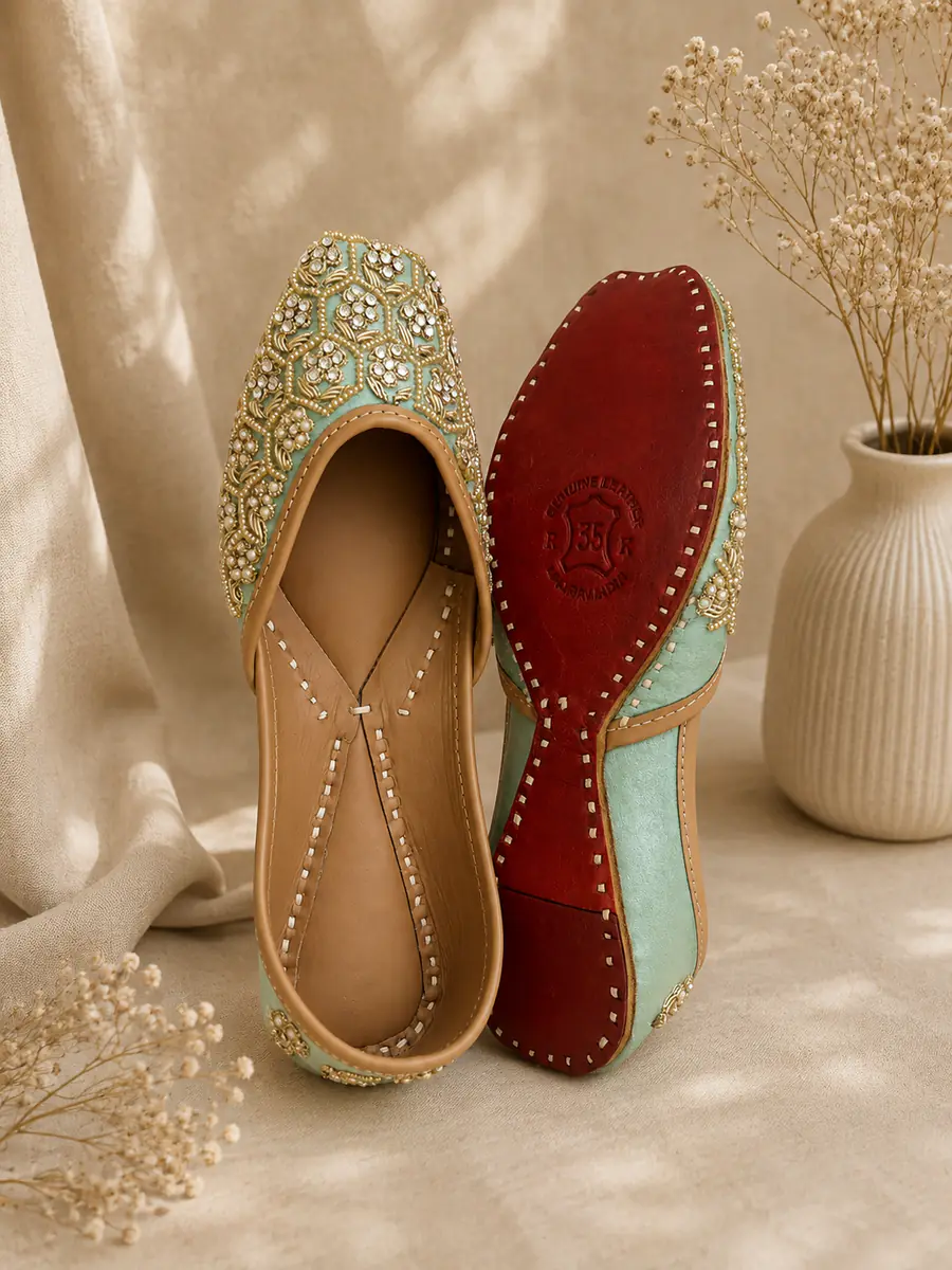 Jade Noor jutti stood beside its red leather sole, stamped Genuine Leather.