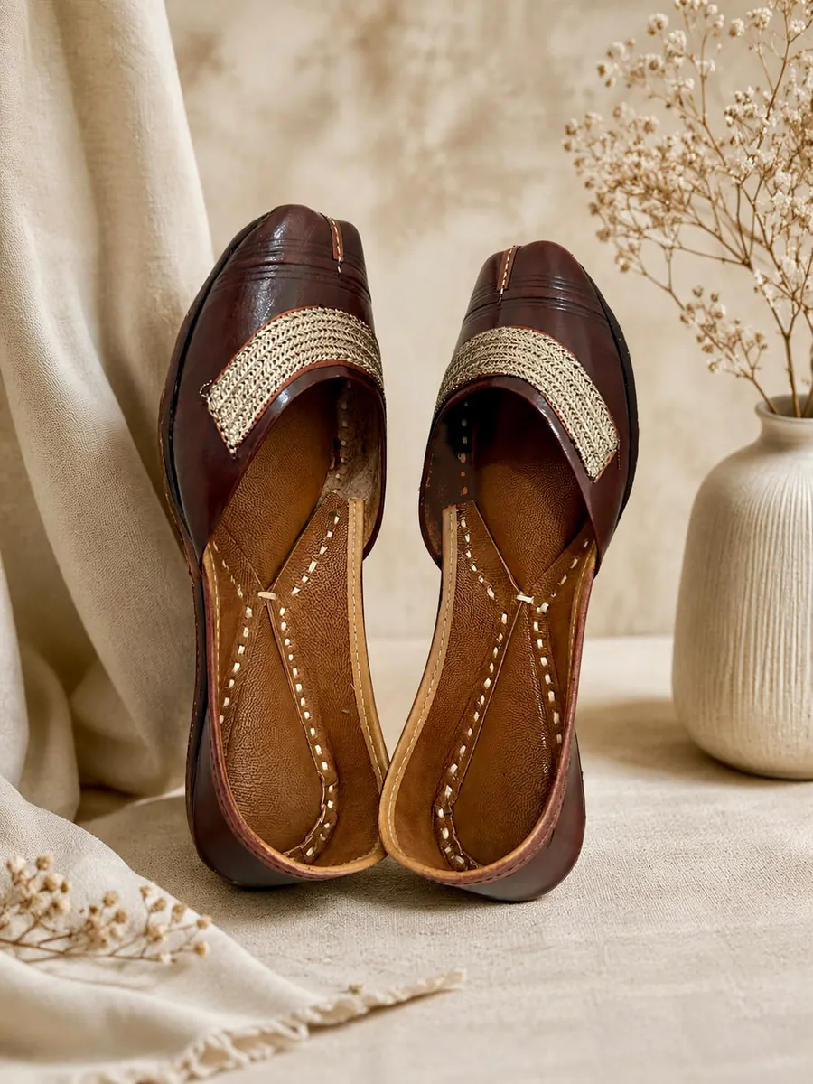 Mocha Grace juttis in deep brown leather with a woven gold band across the toe.