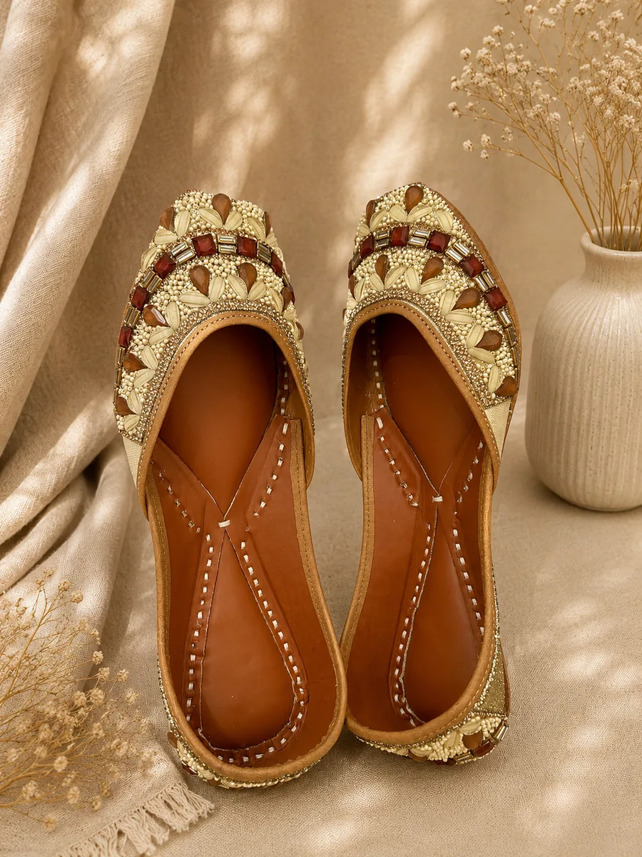 Royal Ember juttis worked in gold, garnet and jewel-toned beadwork.